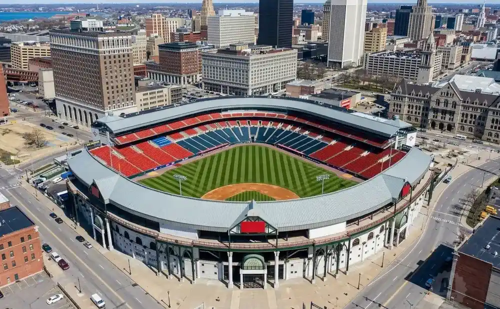 Aerial view of a baseball stadium in an urban setting with surrounding buildings and streets.
