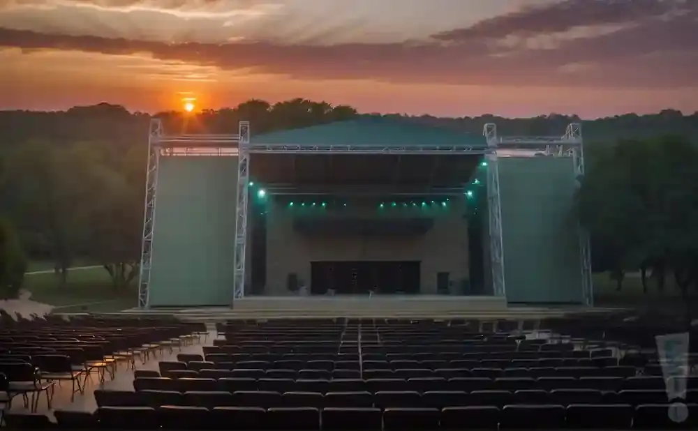 An outdoor amphitheater stage at sunset.