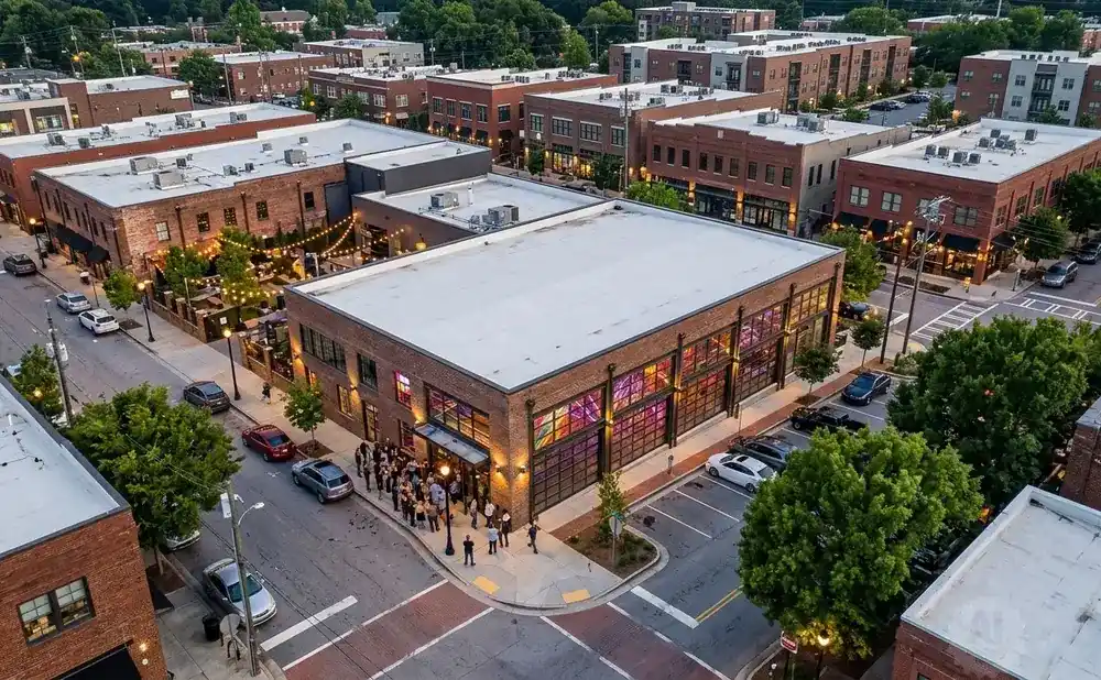 Aerial view of a brick building with colorful stained-glass windows and a crowd gathered outside.