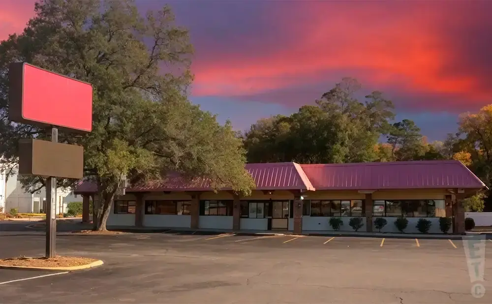 Empty roadside diner with a vibrant red and purple sunset sky.