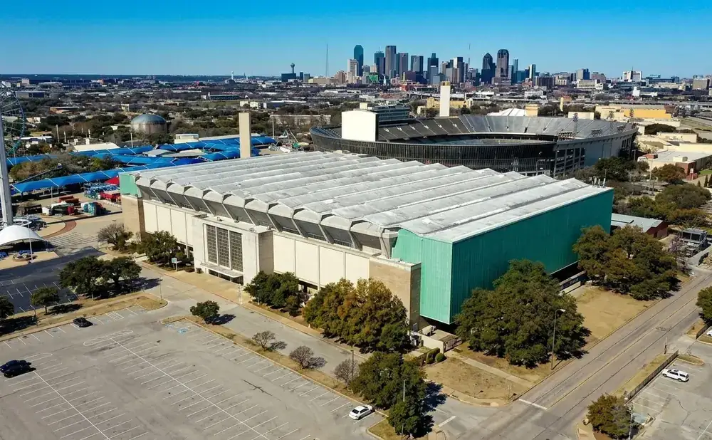 Aerial view of the Dallas Convention Center with the city skyline in the background.