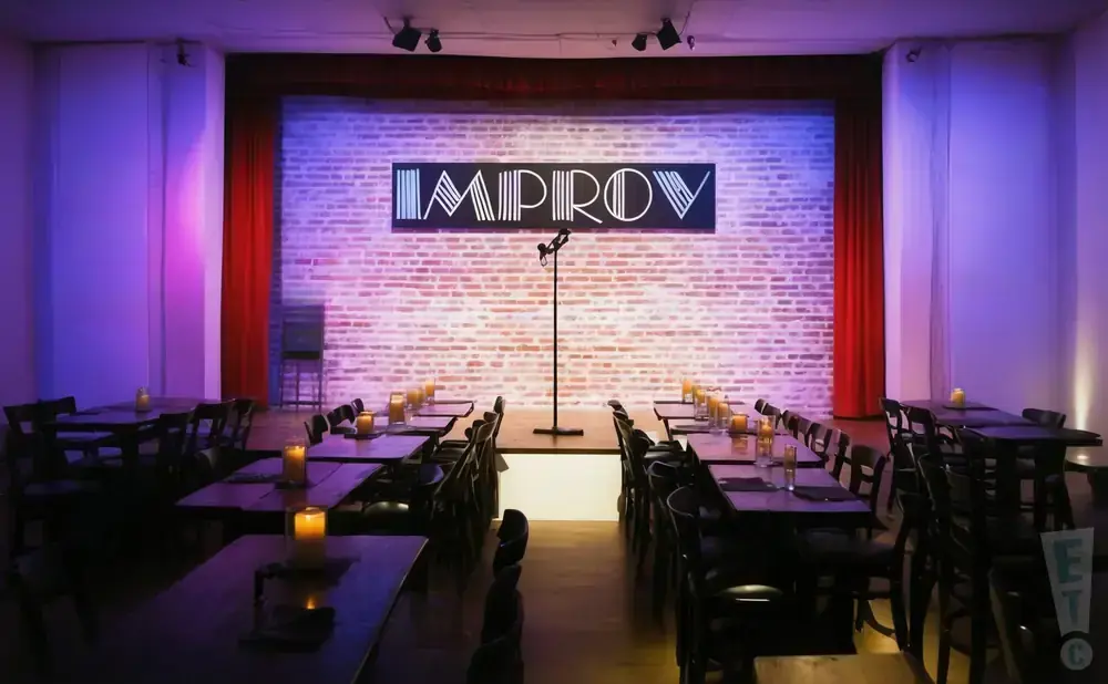 An Improv comedy club stage with brick wall, 