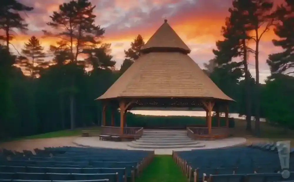 Outdoor amphitheater with a gazebo and seating at sunset.