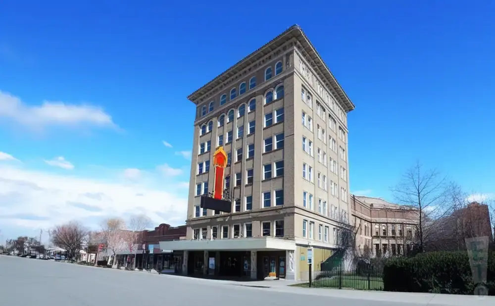 Tall, vintage building with a marquee sign on a sunny day.