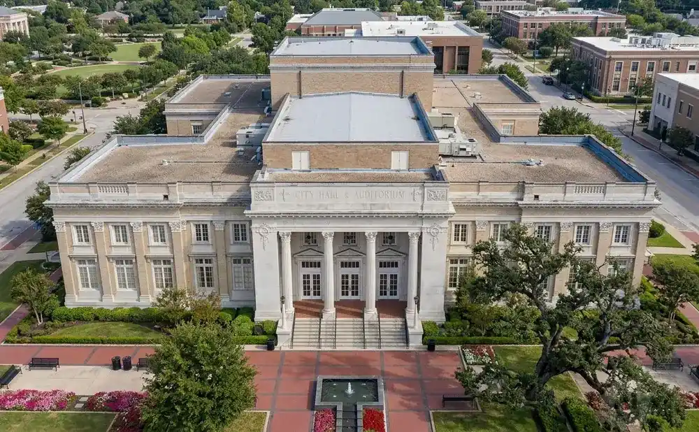 Aerial view of City Hall & Auditorium with grand entrance, columns, and a central fountain.