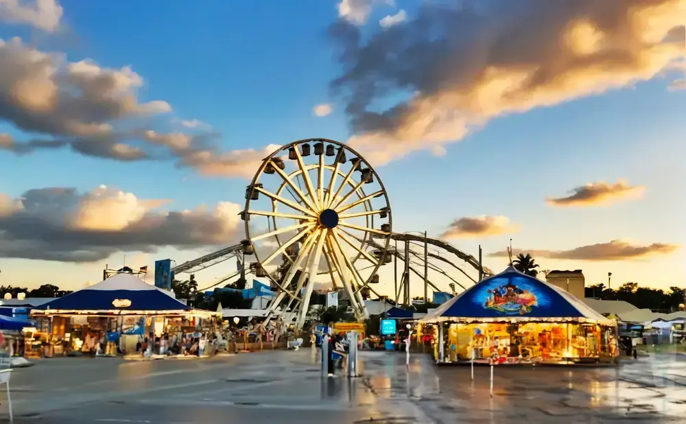 Ferris wheel and carnival tents at sunset.