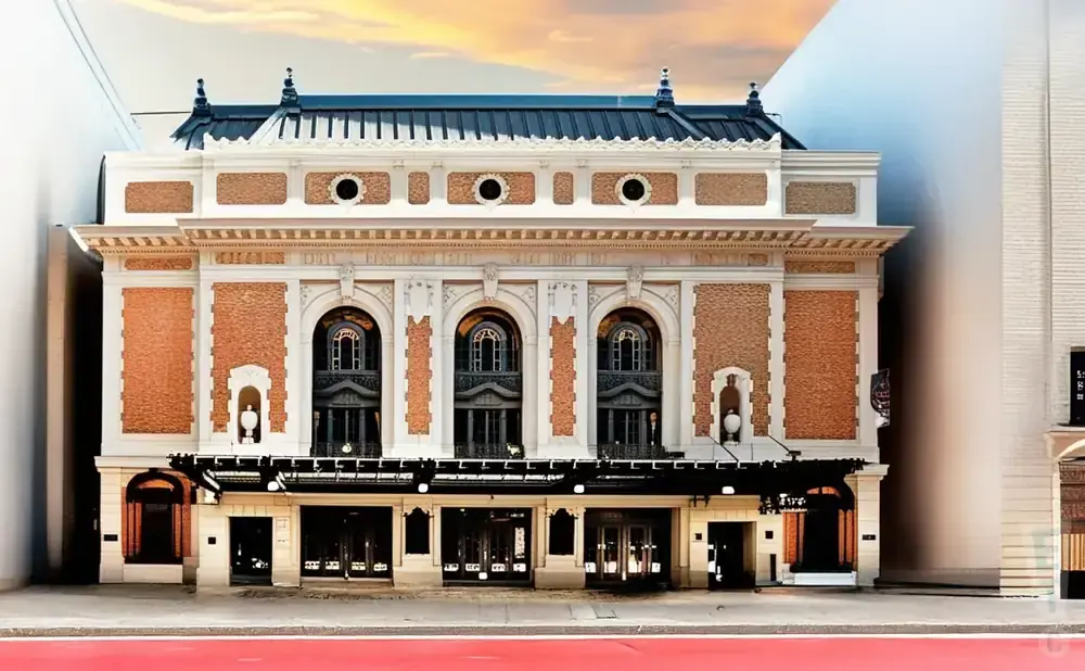 Elegant theater with ornate facade, brick accents, and arched windows.