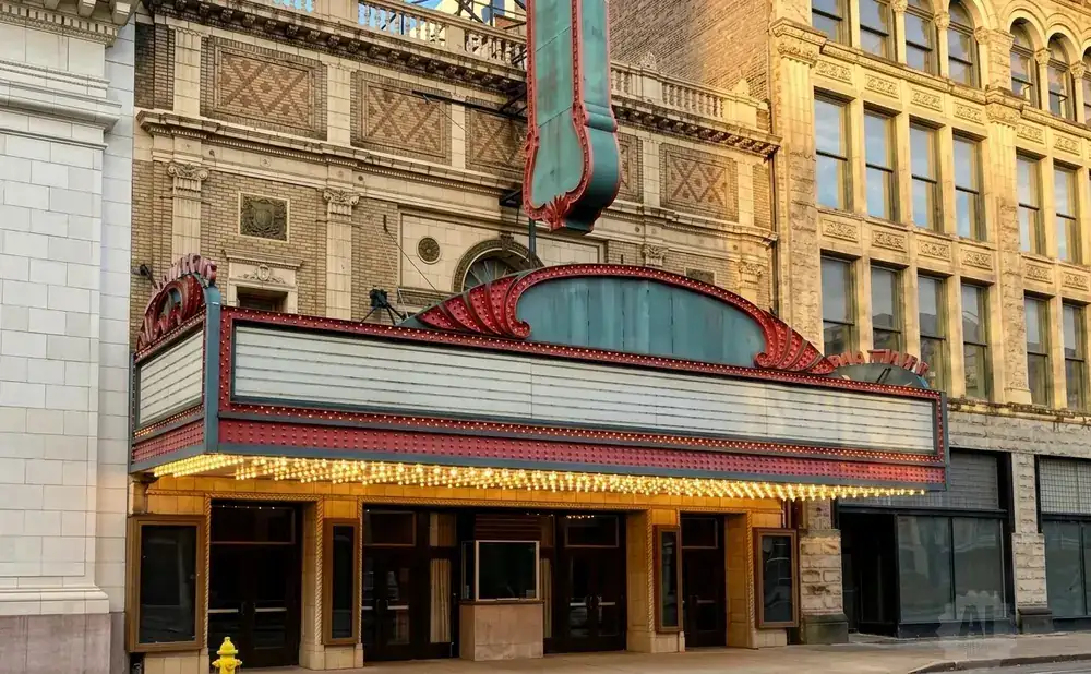 Exterior of a vintage theater with a marquee and ornate architectural details.