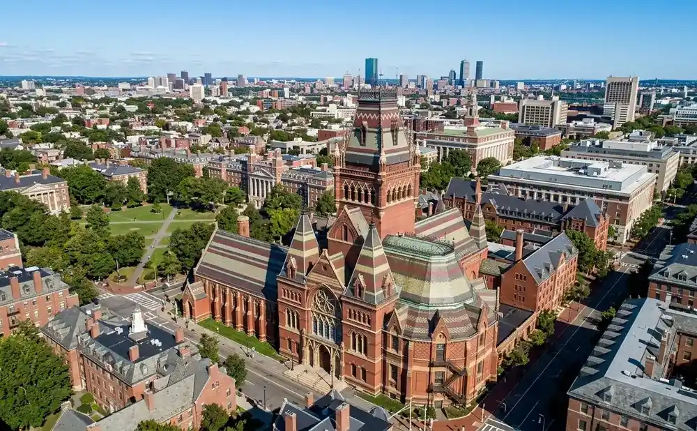 Aerial view of Harvard University's Widener Library and surrounding historic buildings and greenery.