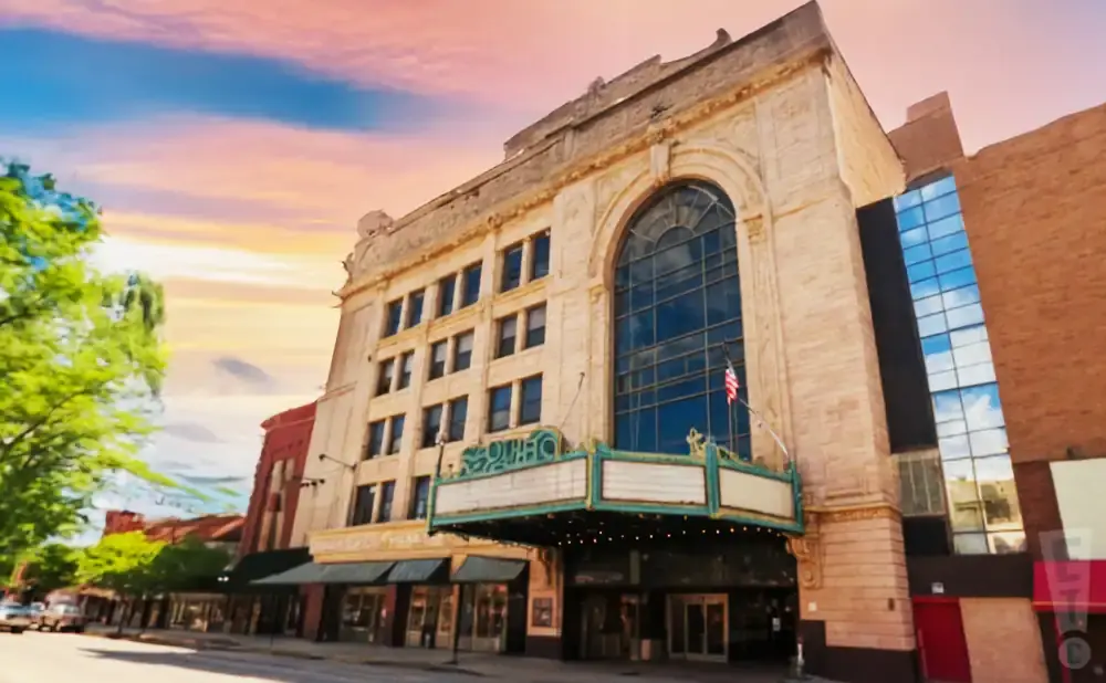 The Ohio Theatre with a marquee and an arched window, under a sunset sky.