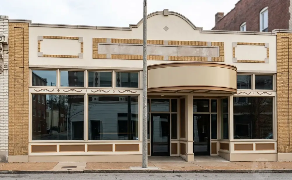 A beige commercial building with a light yellow brick facade and large windows.