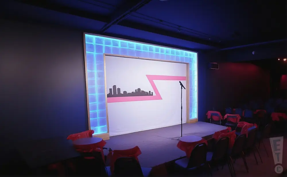 a realistic promo venue photograph of the ann arbor comedy showcase at night.