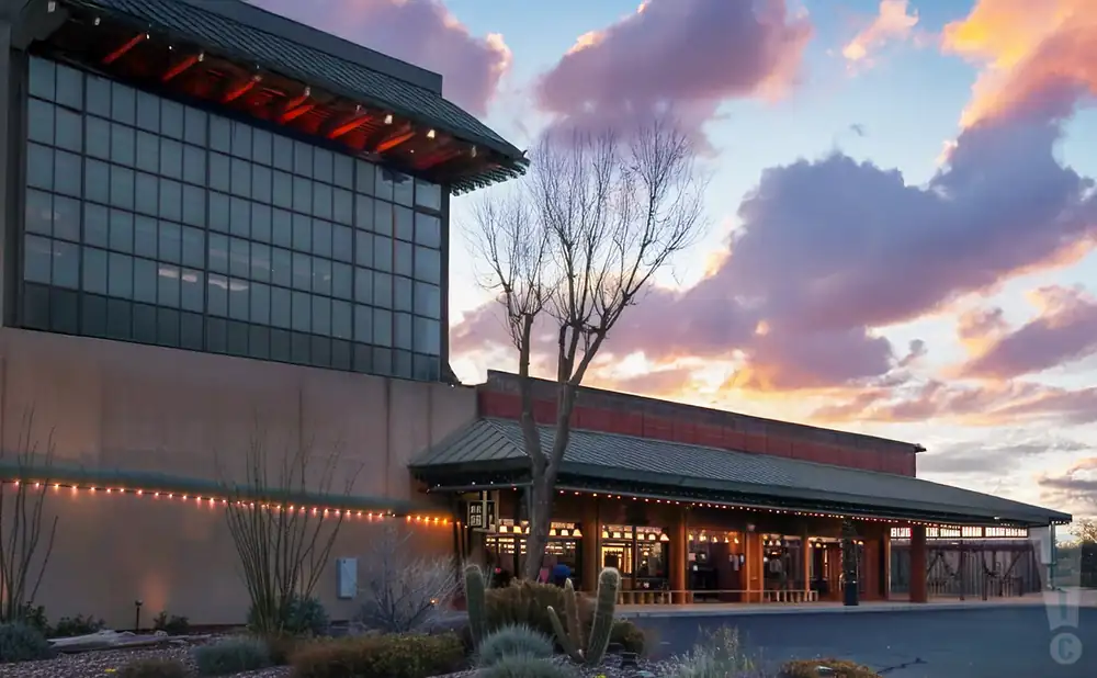 an exterior promotional venue picture of cactus petes gala showroom with a sunset sky