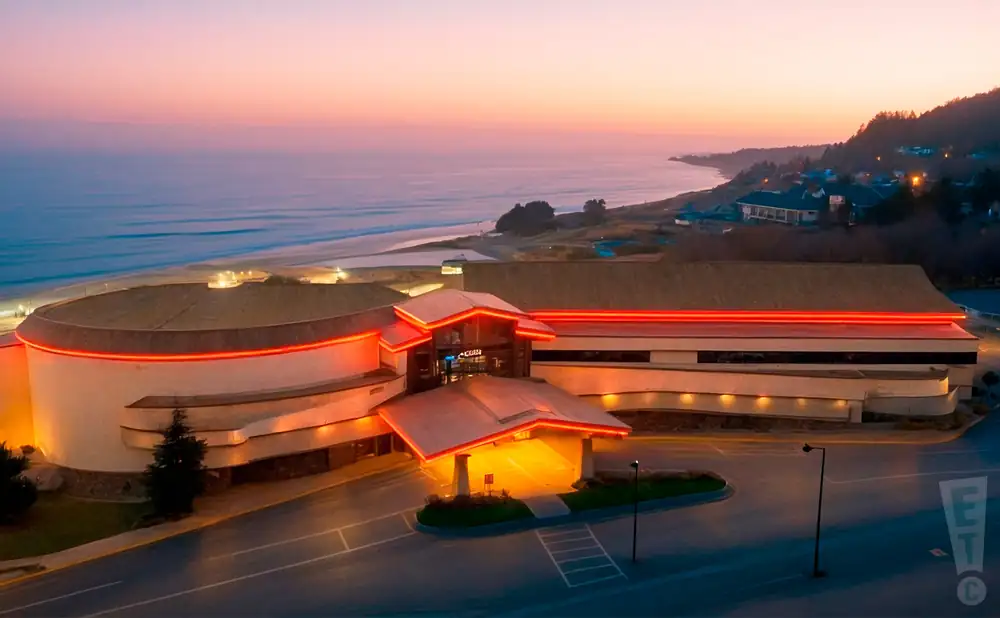promotional exterior photograph of chinook winds casino resort, taken at sunset along the oregon coast. 