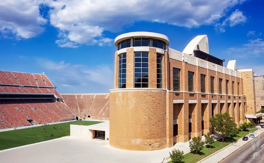 an exterior promotional venue picture of darrell k royal texas memorial stadium with a sunny sky