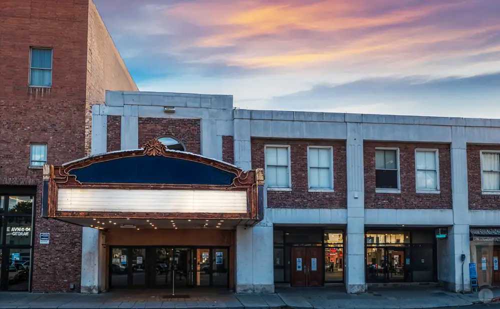 an exterior promotional venue picture of flynn center for the performing arts with a sunset sky
