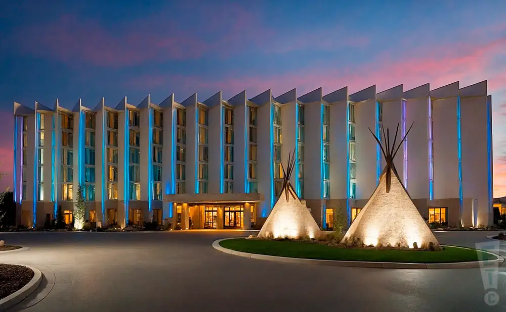 a promotional exterior photograph capturing the full front view of the grey eagle resort & casino in calgary at dusk.