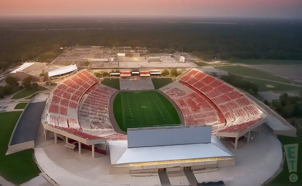 a realistic drone promo venue photograph of jack trice stadium at sunset.