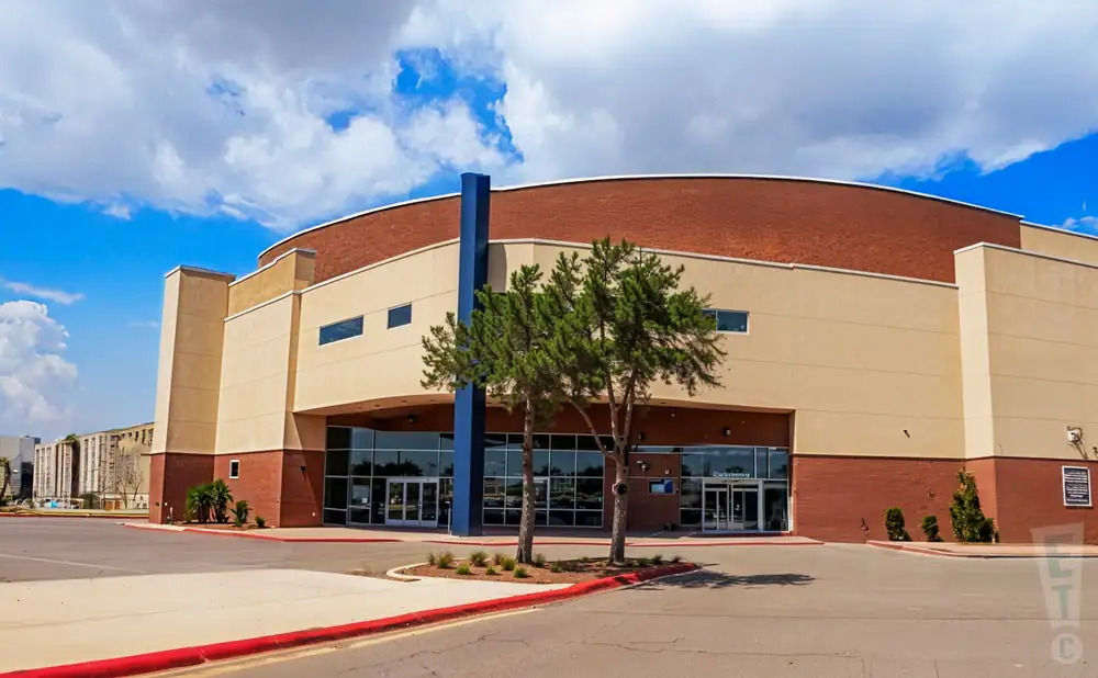 an exterior promotional venue picture of sames auto arena with a sunset sky