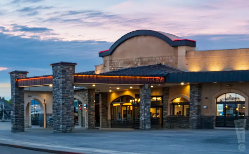 an exterior promotional venue picture of the pearl showroom at pure casino yellowhead with a sunset sky