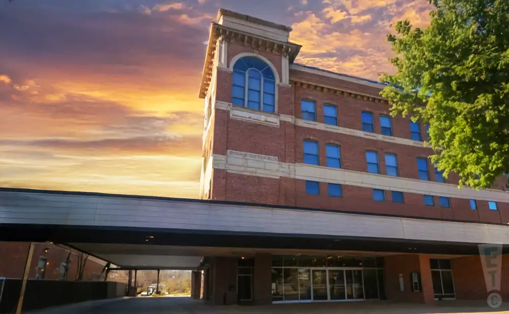 an exterior promotional venue picture of williamsport community arts center with a sunset sky