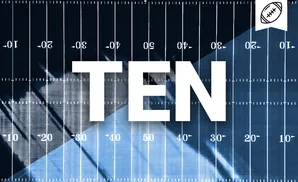 An American football field with yard markers and a football emblem in the top right corner.