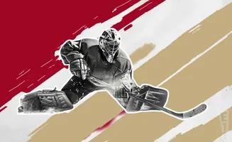 A hockey goalie in pads and mask dives to make a save, stick out to block a shot.