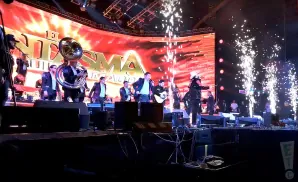 A band performs on stage with fireworks.