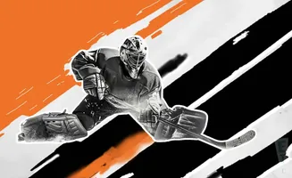 Hockey goalie in protective gear lunges to block a shot, with orange and black abstract designs in the background.