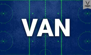 Hockey rink with blue and green markings. A small banner with crossed hockey sticks is in the upper right corner.