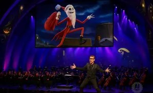 Conductor leads orchestra with Jack Skellington projection.