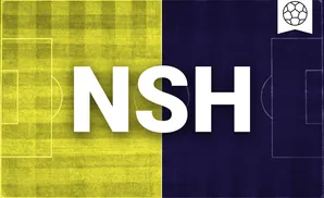 a nashville sc soccer player kicking the ball down field