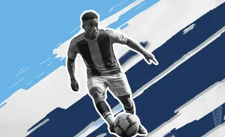 A soccer player dribbles a ball on a blue and white striped background.