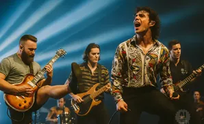 A band performs on stage with a vocalist in a colorful shirt singing into a microphone.
