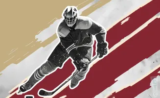 A hockey player in a mask and uniform skates with a stick.