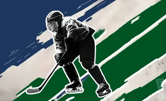 A hockey player in a dark uniform skates forward with a stick on a background of blue and green stripes.