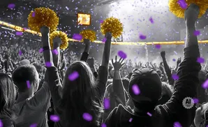 A crowd celebrates with gold pom-poms and purple confetti.
