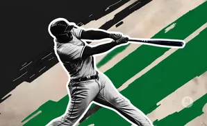 A baseball player swings a bat with a blurred, abstract background of green and black.