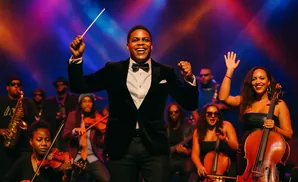 A conductor leads an orchestra playing various instruments including violins, a cello, and a saxophone.