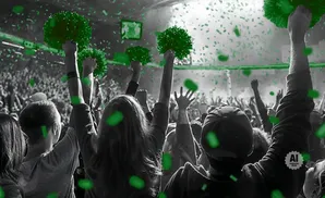 Crowd at a concert with green confetti and pom-poms.