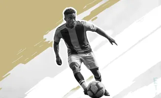 Black and white image of a soccer player in action, dribbling a ball.