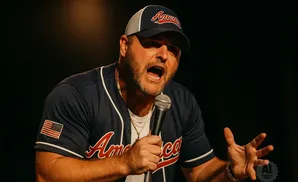Man in a baseball cap and jersey with an American flag patch and 