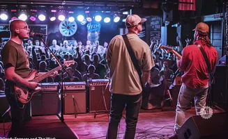 A band plays on stage to a cheering crowd.
