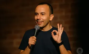 Comedian holds a microphone and makes an 