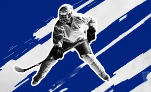 A hockey player in full gear skates with a stick, on a blue and white abstract background.