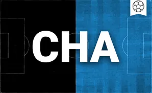 a charlotte fc soccer player kicking the ball down field 