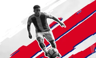 A soccer player in black and red jersey dribbles the ball against a red and white background with blue stripes.