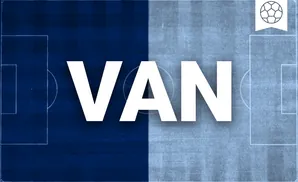 a vancouver whitecaps fc soccer player kicking the ball down field