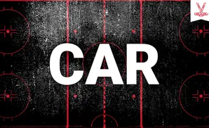 A hockey rink with red markings on a textured black surface.