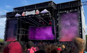A stage at the Sueños music festival, with large purple screens displaying a starry sky.